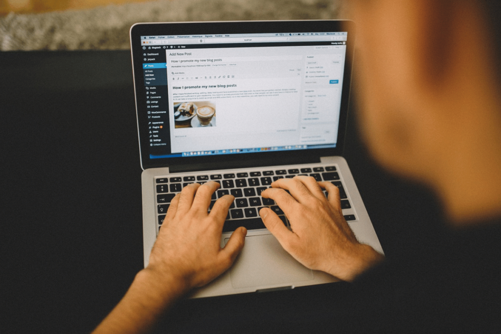 Blogger creating a new post on a WordPress dashboard on a MacBook.