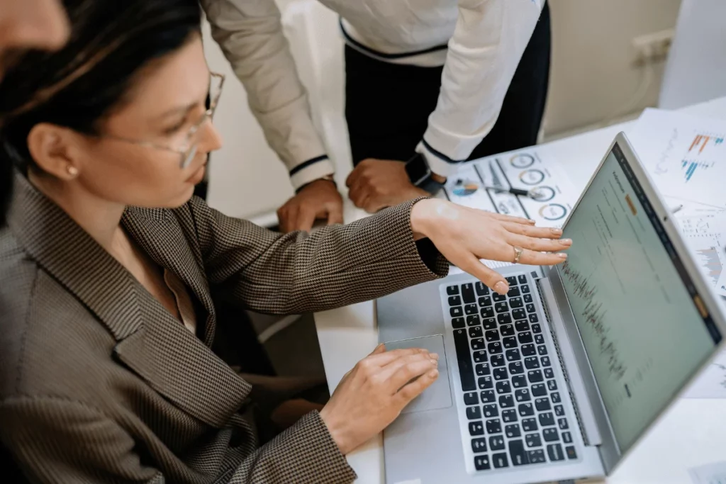 Strategic analysis meeting with laptops and documents.