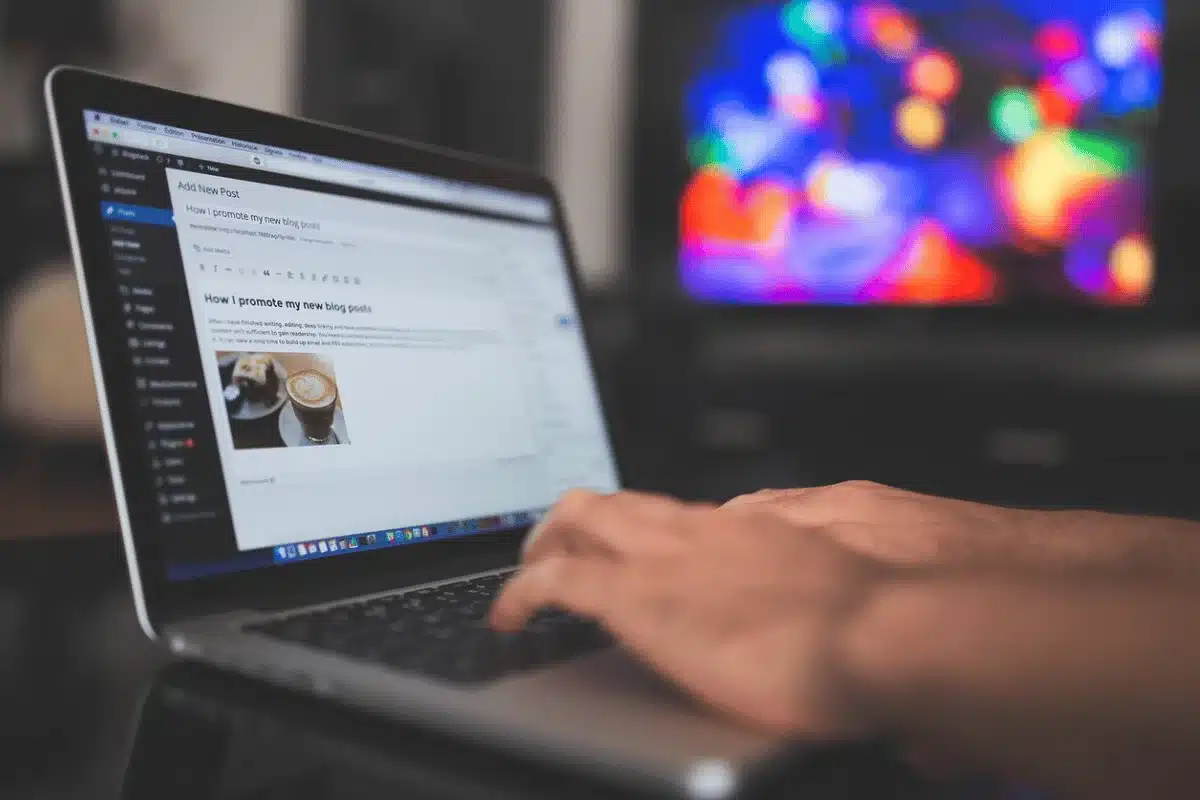 Focused blogging session, crafting content on a laptop with a soft-focus light display.