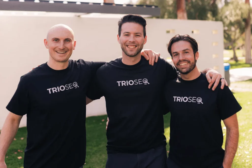 Outdoor group shot with Nathan, Steven, and Connor wearing TRIOS&reg; branded shirts.